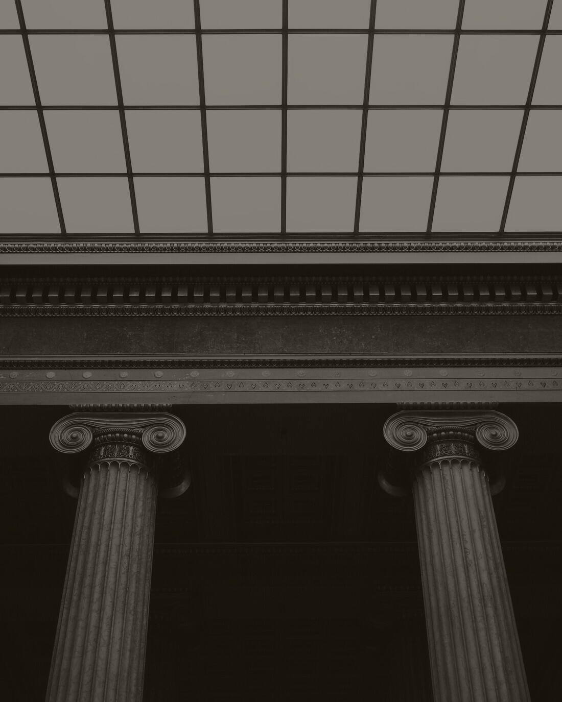 Classical stone columns beneath a high skylight
