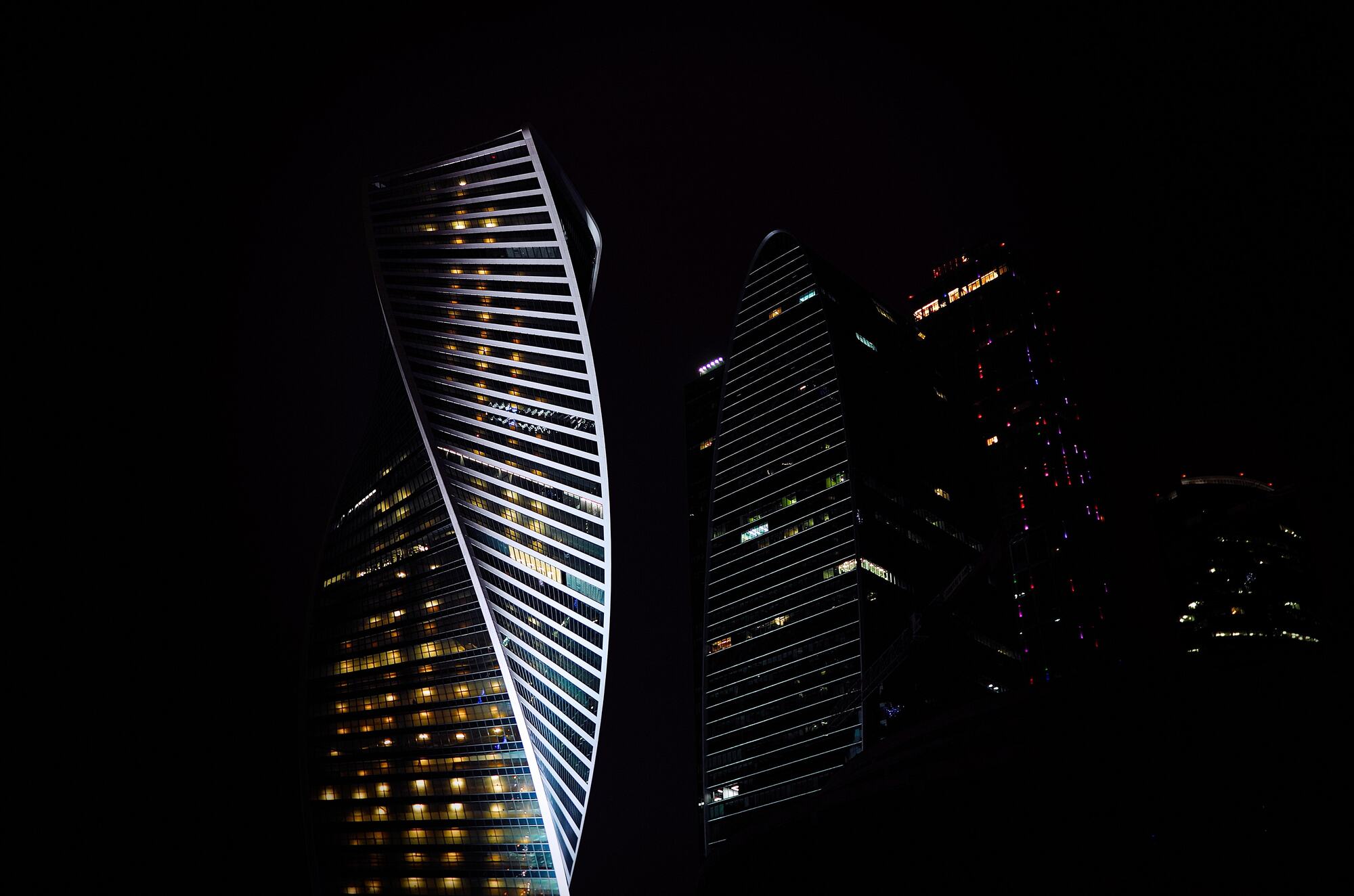 Dark towers at night seen against a black sky
